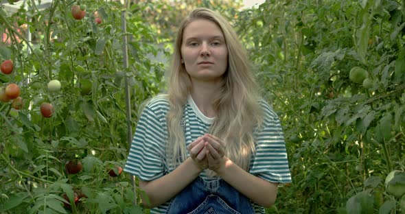 Woman Shows Tomatoes in Her Hands to the Camera