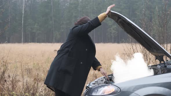Business Woman Open the Hood and Looking at Car Smoke Engine