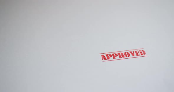 A Stamp Approved is Placed on a Sheet of White Paper Copyspace Compocition alt