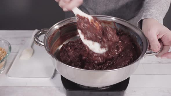 Step by step. Melting chocolate chips in the cooking pot to make macadamia nut fudge. alt