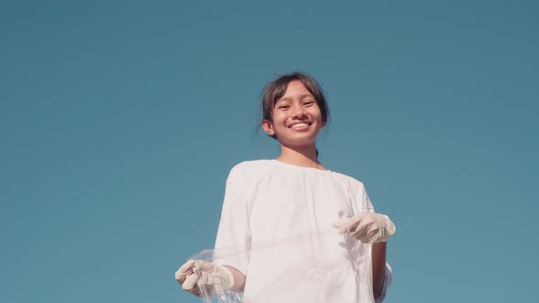 Young Female Volunteer Showing Thumbs-Up alt