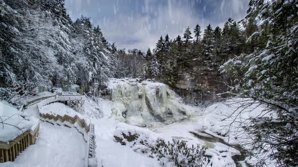 Cinemagraph of Blackwater Falls in winter with ice and snow while snowing heavily. alt