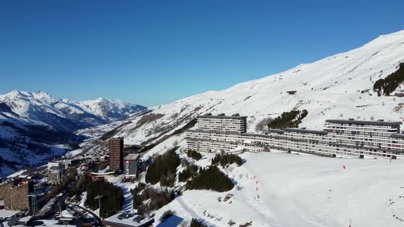 Majestic Winter Aerial Landscape and Ski Resort with Typical Alpine Wooden Houses in French Alps