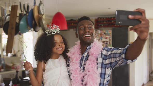 African american father and daughter disguised and taking selfie alt