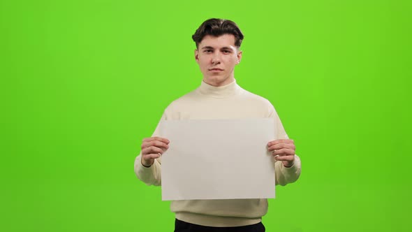 The Man is Standing and Looking at the Camera alt