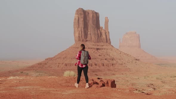 Cinematic Female Traveler Walking in Scenic Red Desert Park Landscape View alt