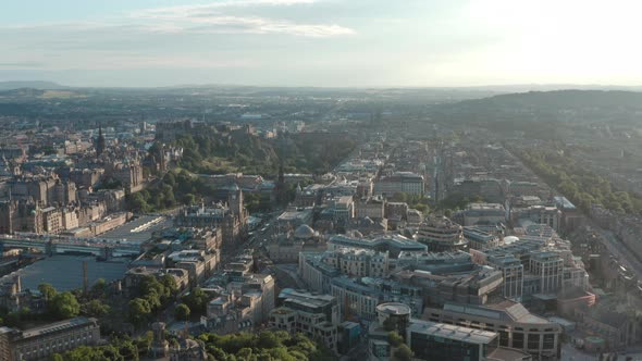 Wide rising drone shot of Edinburgh New Town West End at sunset alt