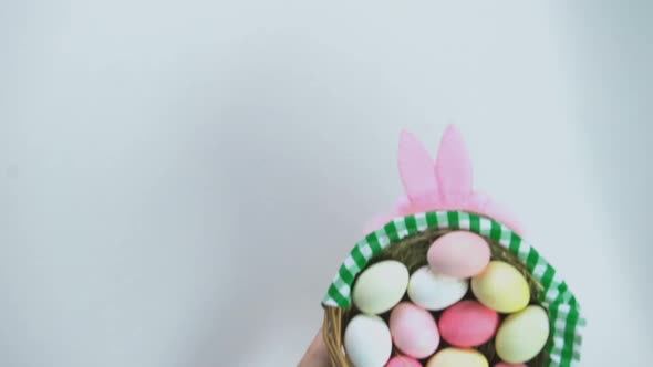 Happy Easter Inscription, Female Hands Putting Basket With Colored Eggs on Table alt