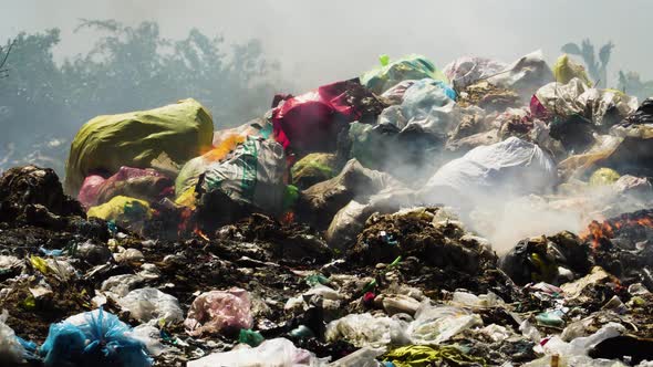Air pollution by illegal burning pile of plastic trash landfill in Vietnam, alt