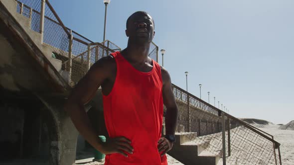 Focused african american man admiring view, taking break in exercise outdoors alt