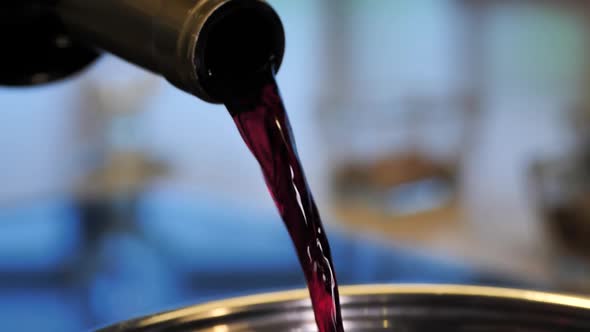 Red Wine Is Poured Into the Pan for Cooking Mulled Wine alt