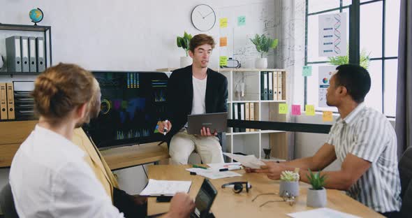 Business Team Presenting the Graphs of Growth of the Company Profits alt