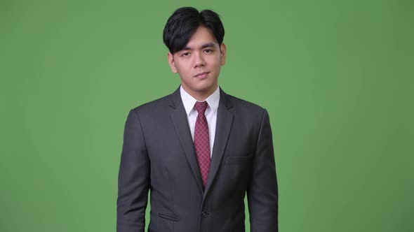 Young Handsome Asian Businessman Nodding Head No alt