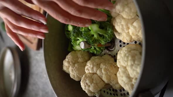 Vertical Of Chopped Cauliflower And Broccoli Placed On Steamer Pan. Close Up alt