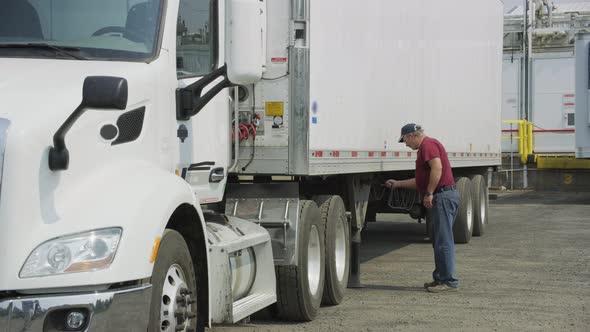 Truck driver preparing trailer.  Fully released for commercial use.