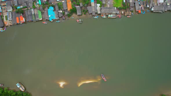 A drone is flying over a fishing village alt