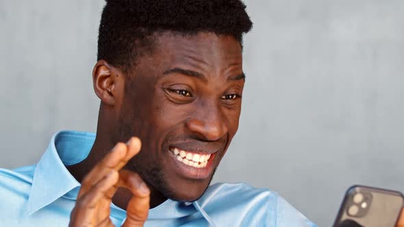 Smiling young student talking using smartphone alt