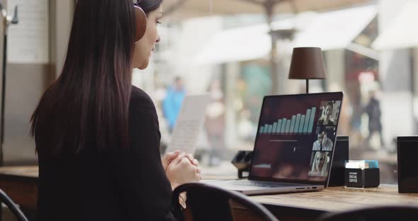 Back View of Caucasian Woman Working on a New Project in a Coffee Shop alt