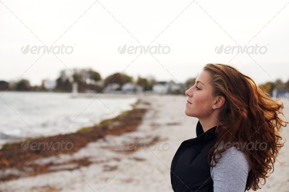 Young woman relaxing on beach - Stock Photo - Images