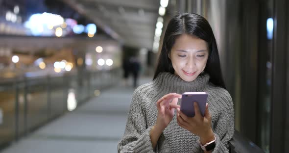 Woman use of mobile phone at night alt
