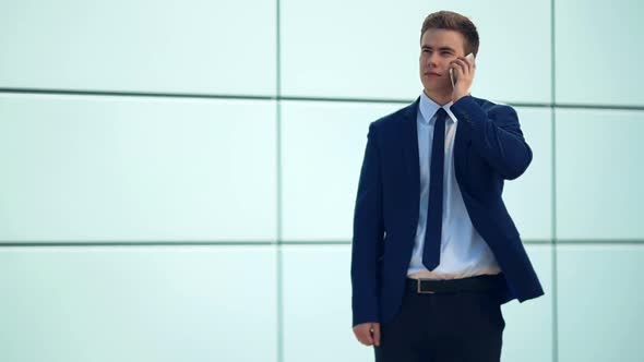 Handsome Businessman Talking at Phone alt