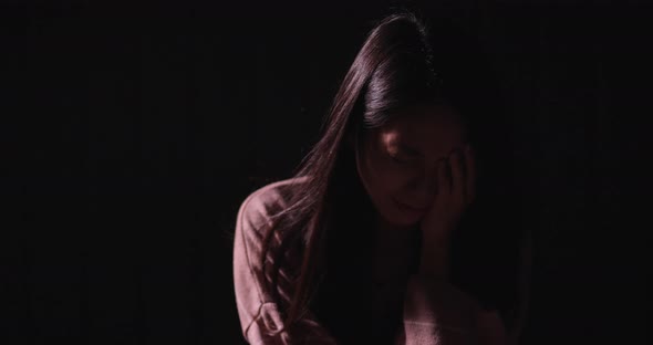 Woman crying in the dark alt