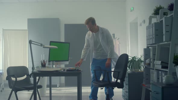 Doctor Examining Xray Patient Using Greendscreen Computer alt