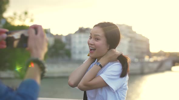 Couple taking a photo at sunset in Paris, France