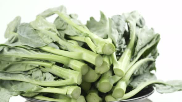 Kale fresh green leaves rotating turning and macro close up on the white background alt