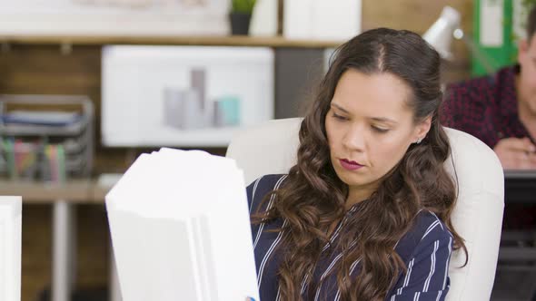Young Female Architect Holding Building Model in the Office alt