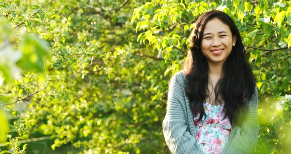 Woman Taking Off Her Face Mask Enjoying Fresh Air in Park