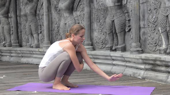 Woman Practicing Yoga During Yoga Retreat in Asia Bali Meditation Relaxation in Abandoned Temple alt