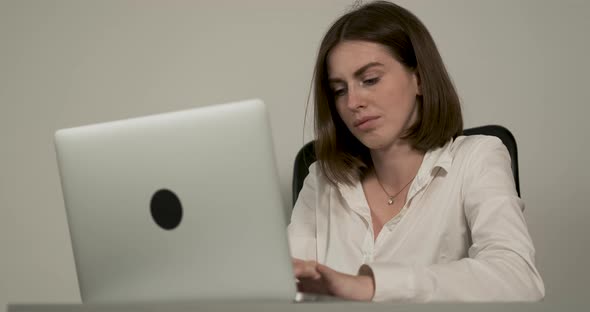 Confident Young Woman Working at the Office Workplace By Laptop Female Manager at Work