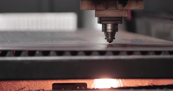 Automated Laser Cutting Of Metal Sheet With Sparks Underneath