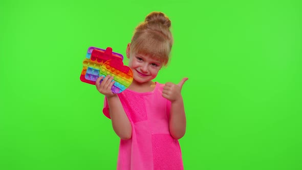 Child Girl Holding Many Colorful Squishy Silicone Bubbles Pop It Popular Sensory Toys Thumb Up alt