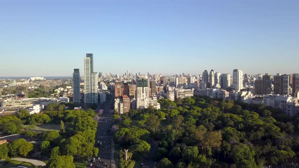 Aerial lowering of beautiful parks and Buenos Aires skyline at golden hour alt