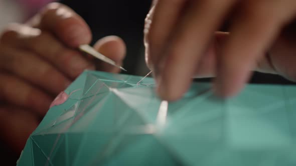 Close-up: a man works with a blade. Production of decorative elements. Workshop. alt