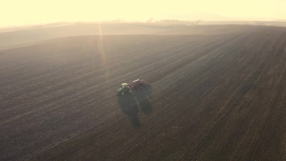 Aerial View Of Harvest Fields. Tractor Driving Across The Field alt