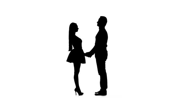Guy with the Girl Hugs and Looks at the Sky. Silhouette. White Background. Slow Motion alt
