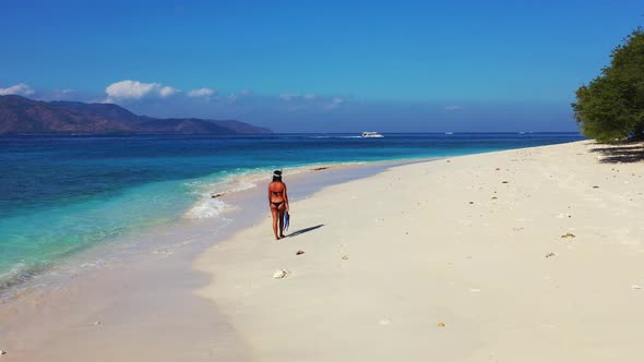 Young beauty models on vacation enjoying life on beach on summer white sand and blue background 4K alt