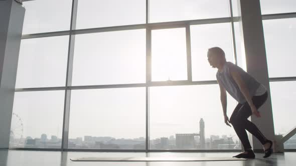 Silhouette Of Girl Spreading Yoga Mat alt