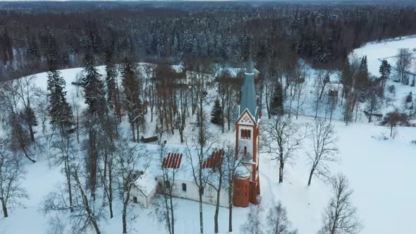 Aerial Top View of the Krimulda Evangelic Lutheran Church in Winter at Sunrise Latvia 4k Video alt