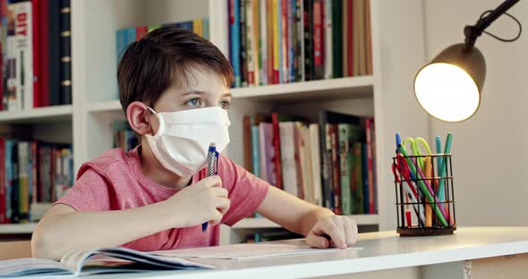 Boy Wearing Face Mask Studying at Home