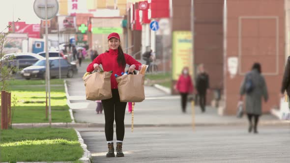Courier with a packages of food on street