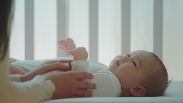 Pretty Baby Girl Laying Down on Her Baby Cot Her alt