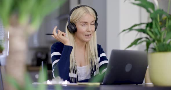 Businesswoman having conference call wearing headphones