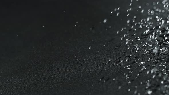 Super Slow Motion Shot of Water Droplets Splashing on Waterproof Cloth at 1000Fps alt