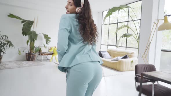Young Business Woman Dances Her Ass Off in the Office Cheerful and Happy for a Job Well Done alt