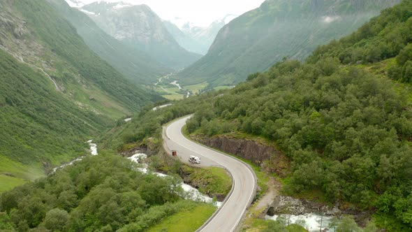 Aerial View Of Road In Mountains And Forest Landscape In Stryn, Norway - drone shot alt