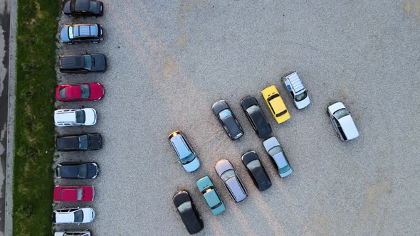 Aerial View of Many Colorful Cars Parked on Parking Lot in Evening alt